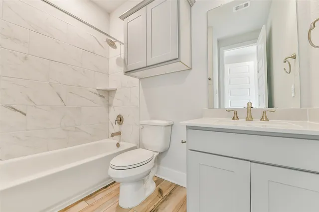 a bathroom with a sink toilet and shower