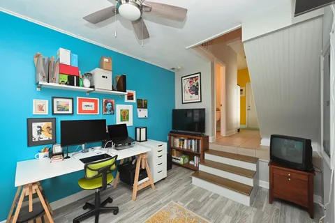 a work room with furniture and a flat screen tv