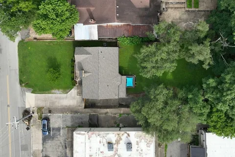 an aerial view of a house with a yard
