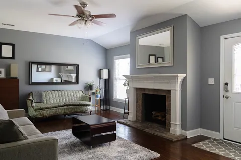 a living room with furniture and a fireplace
