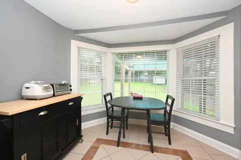 a view of a dining room with furniture and windows