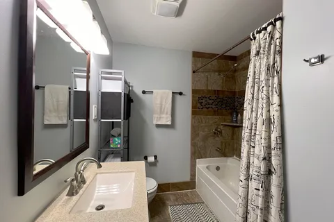 a bathroom with a tub sink and toilet