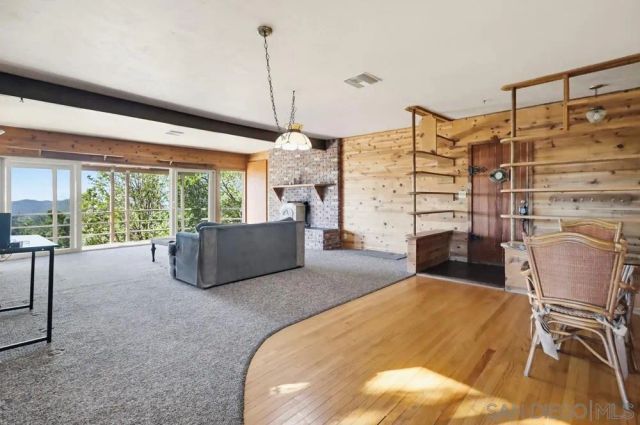 a living room with furniture and a floor to ceiling window