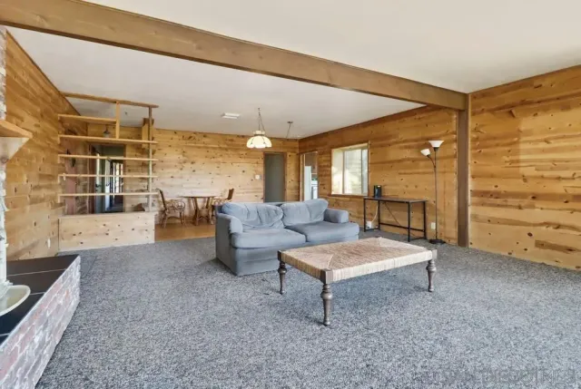 a front view of house with yard and trees around