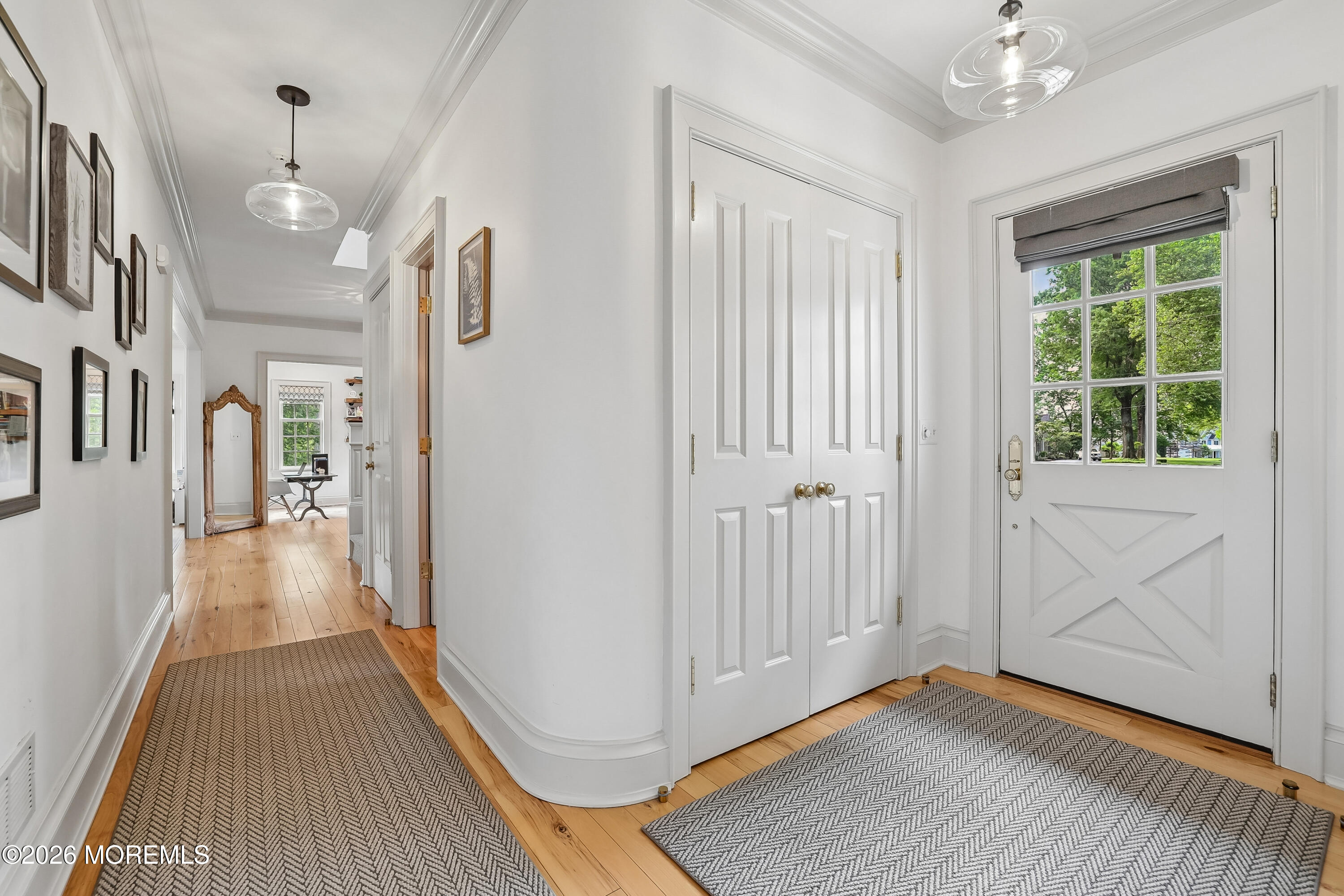 92 Tulip Lane Colts Neck, NJ 07722 - Photo 18 of 55 a view of a hallway with wooden floor and a chandelier