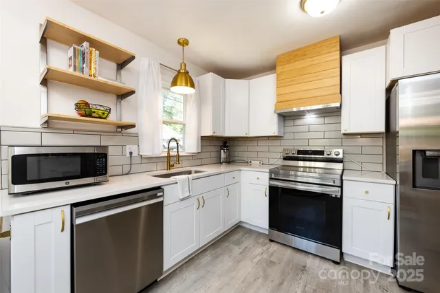 a kitchen with cabinets appliances and a window