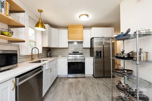 a kitchen with refrigerator and window