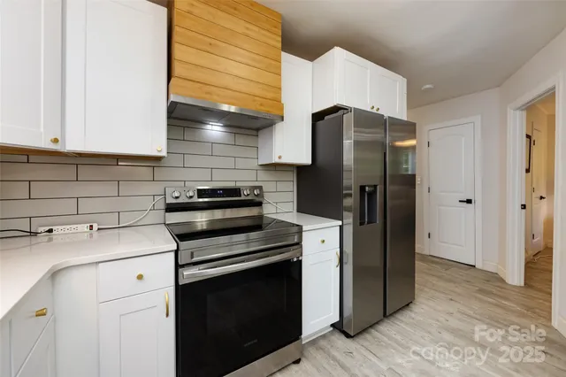 a kitchen with a refrigerator sink and cabinets