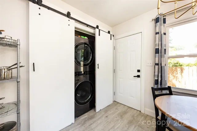 a view of a hallway with wooden floor and door