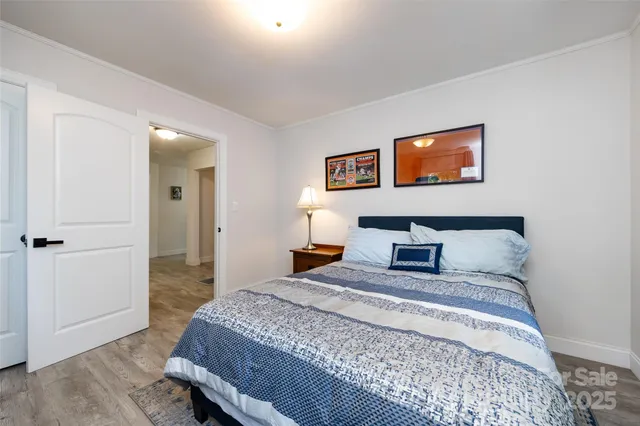 a bedroom with a bed and a painting on the wall