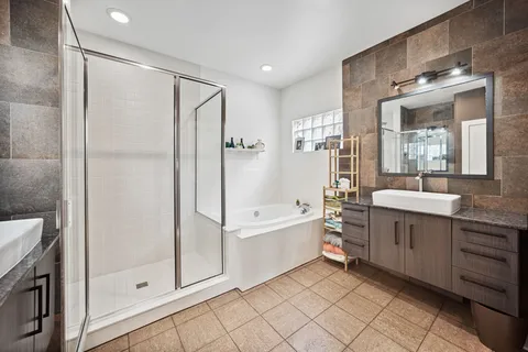 a bathroom with a double vanity sink toilet and shower