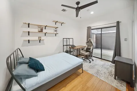 a bedroom with a bed a table and chairs