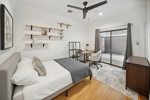 a bedroom with a bed a table and chair