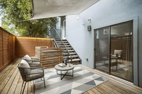 a balcony with table and chairs