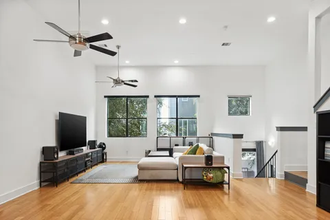 a living room with fireplace furniture and a flat screen tv