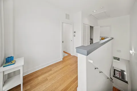 a view of a kitchen with furniture and wooden floor