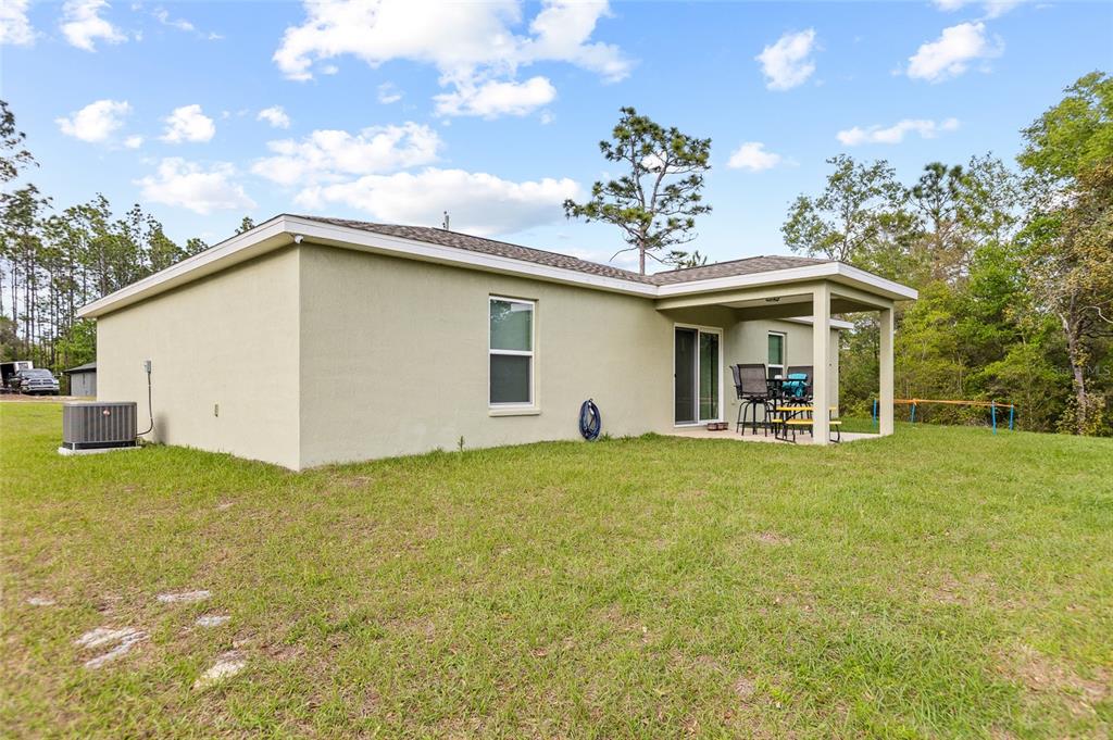 2700 West Rutland Drive Citrus Springs, FL 34434 - Photo 24 of 31 a view of a house with backyard and garden