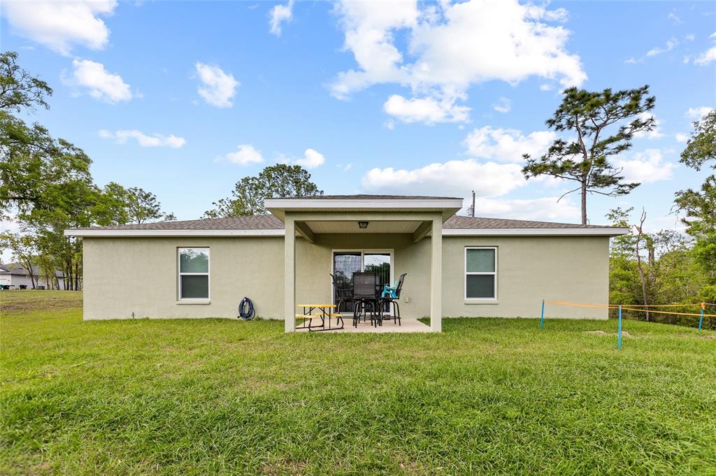 2700 West Rutland Drive Citrus Springs, FL 34434 - Photo 25 of 31 a view of a house with backyard and garden
