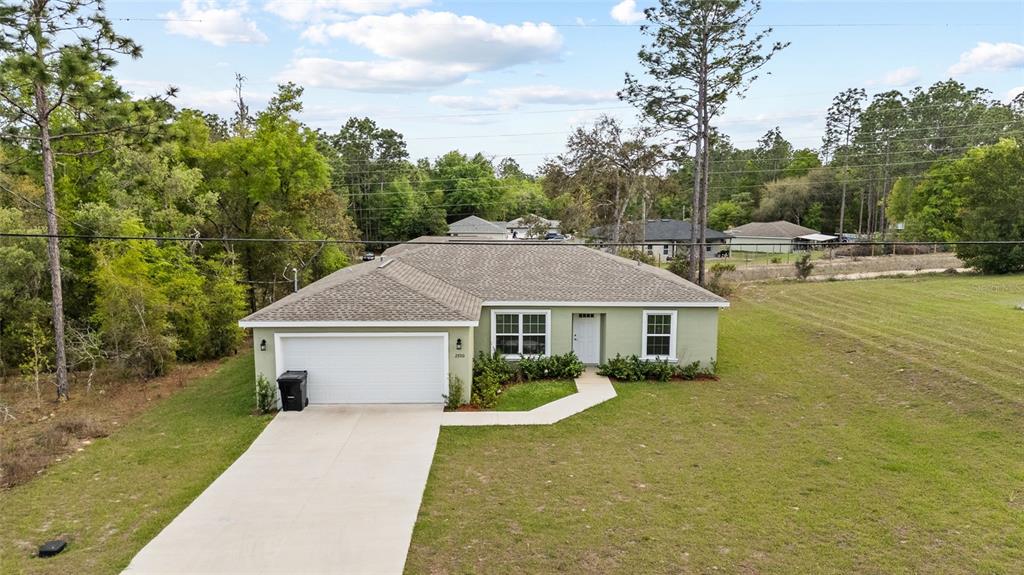 2700 West Rutland Drive Citrus Springs, FL 34434 - Photo 29 of 31 a house with trees in the background