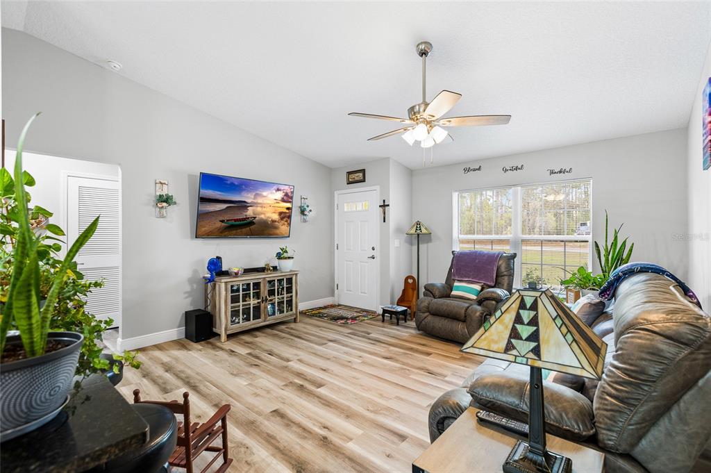 2700 West Rutland Drive Citrus Springs, FL 34434 - Photo 5 of 31 a living room with furniture and a potted plant