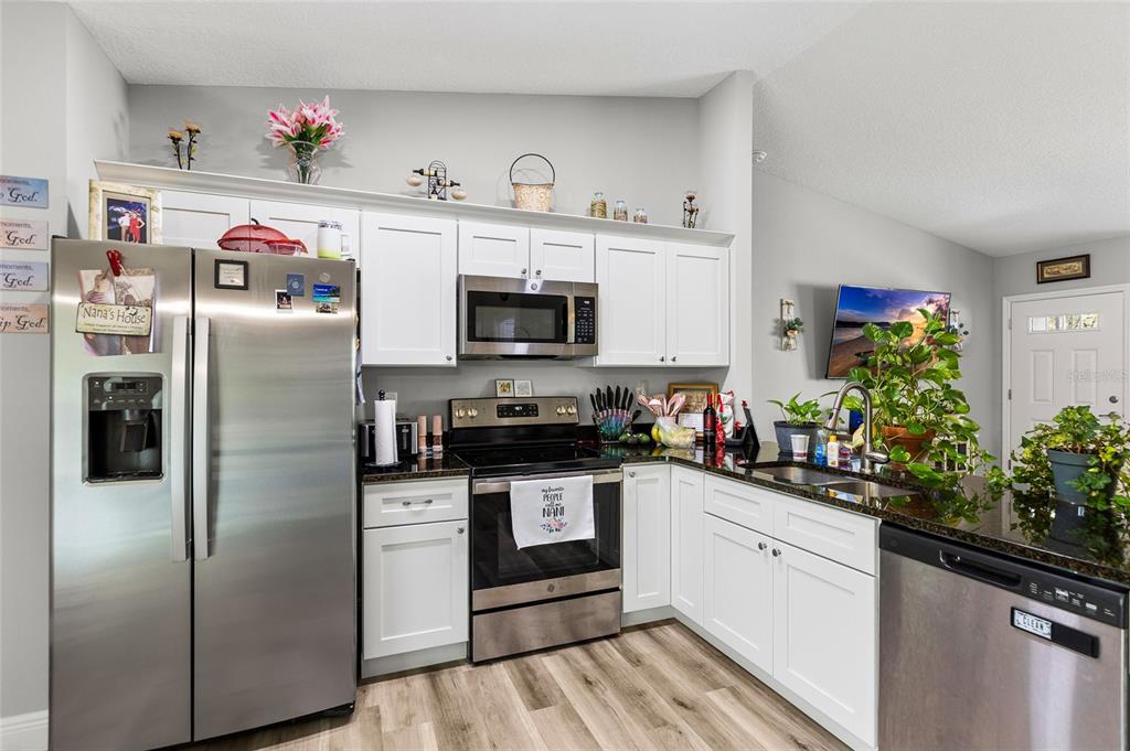2700 West Rutland Drive Citrus Springs, FL 34434 - Photo 8 of 31 a kitchen with stainless steel appliances a refrigerator sink and cabinets