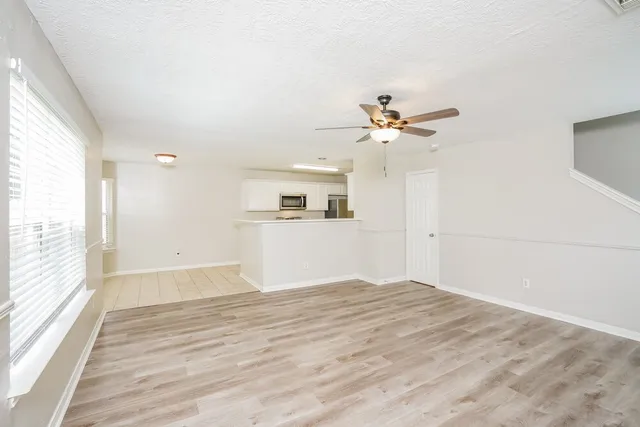 wooden floor in an empty room with a window