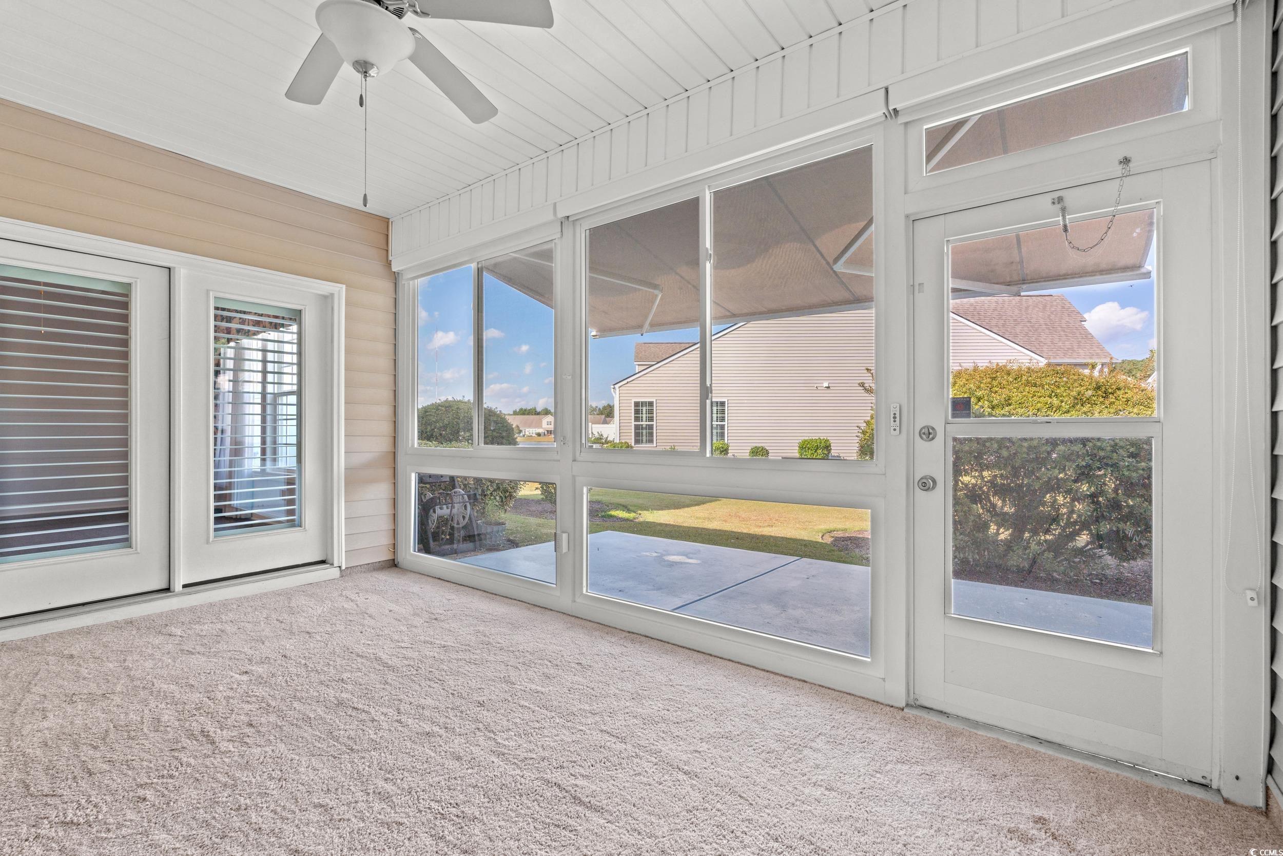 135 Parmelee Drive, Unit C Murrells Inlet, SC 29576 - Photo 19 of 37 Unfurnished sunroom featuring ceiling fan