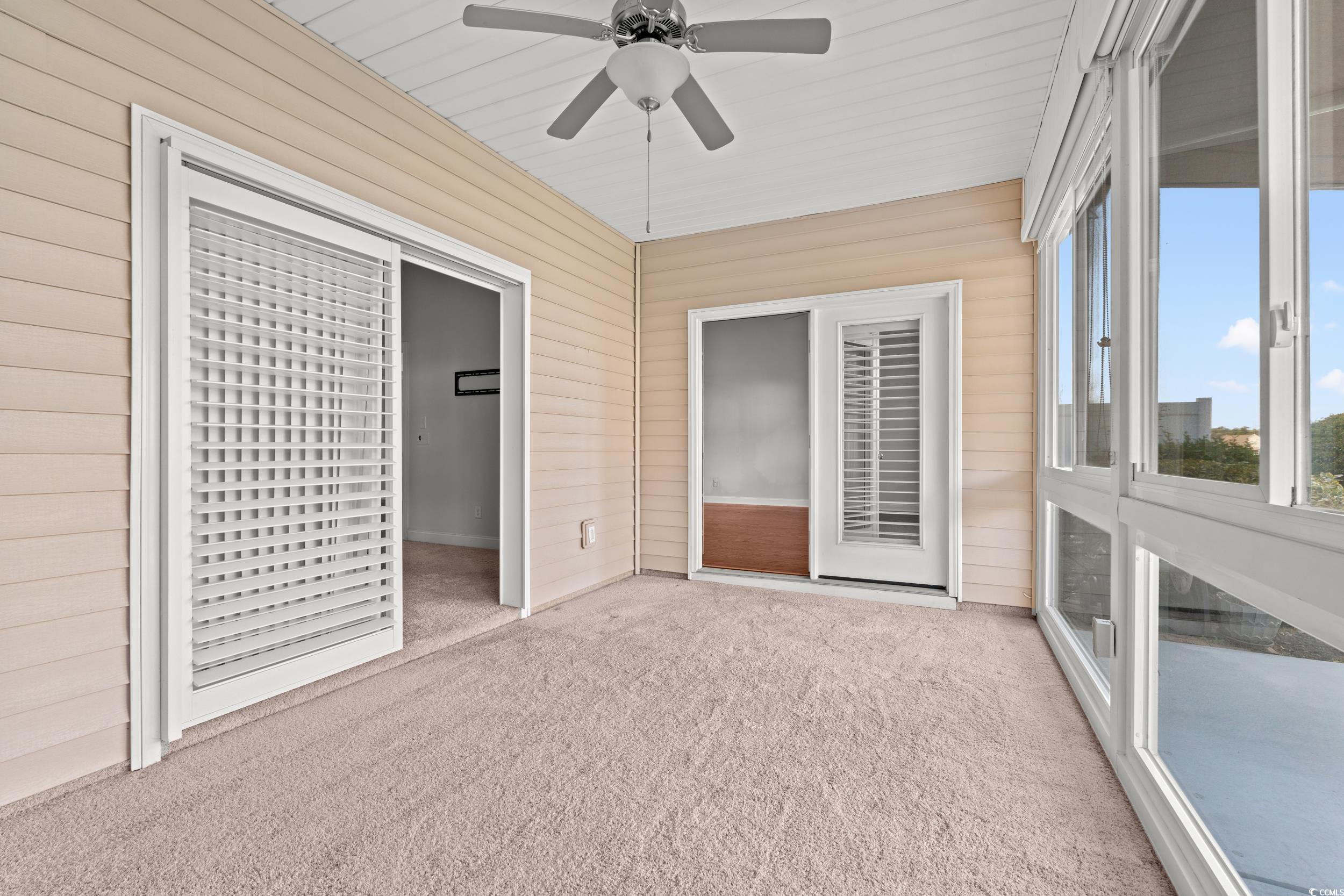135 Parmelee Drive, Unit C Murrells Inlet, SC 29576 - Photo 20 of 37 Unfurnished sunroom with ceiling fan
