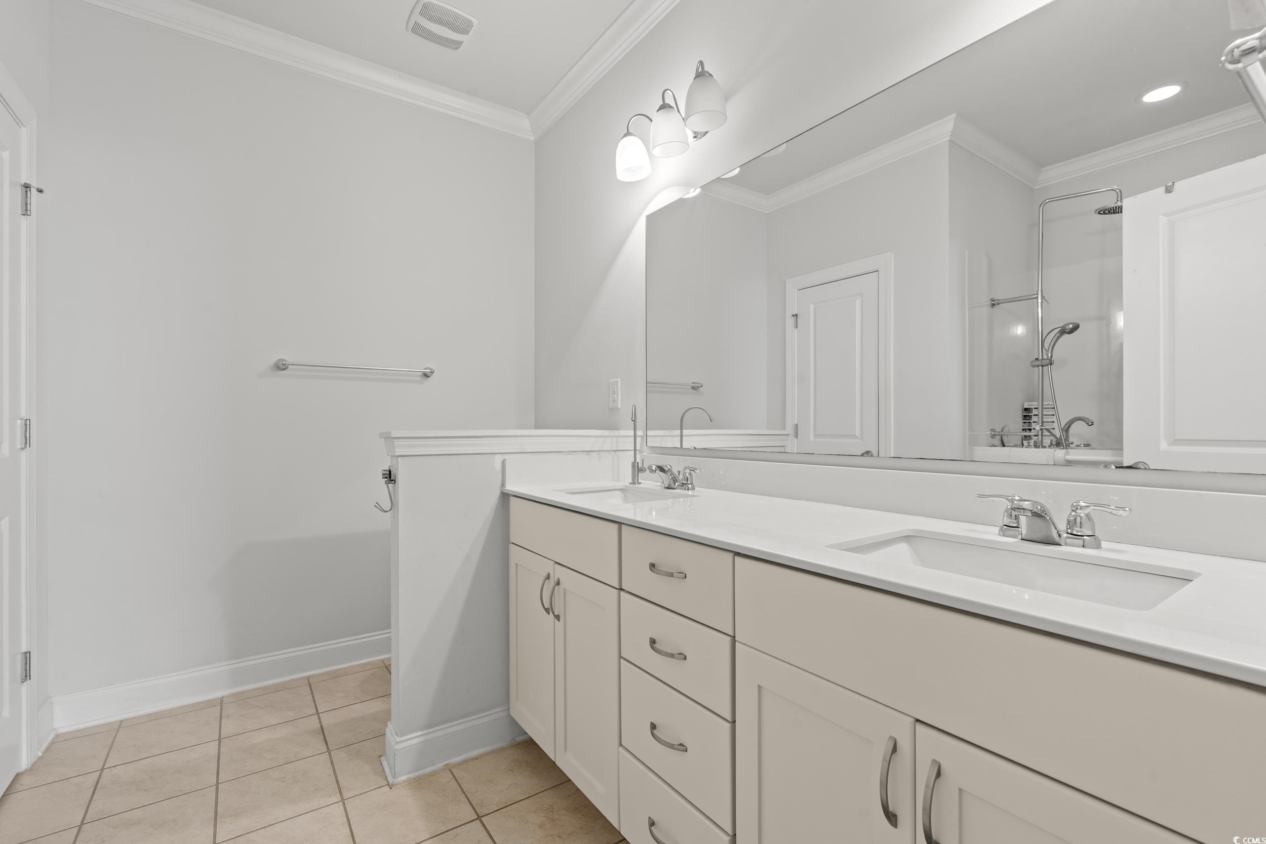 135 Parmelee Drive, Unit C Murrells Inlet, SC 29576 - Photo 21 of 37 Bathroom featuring double vanity, ornamental molding, and light tile patterned floors