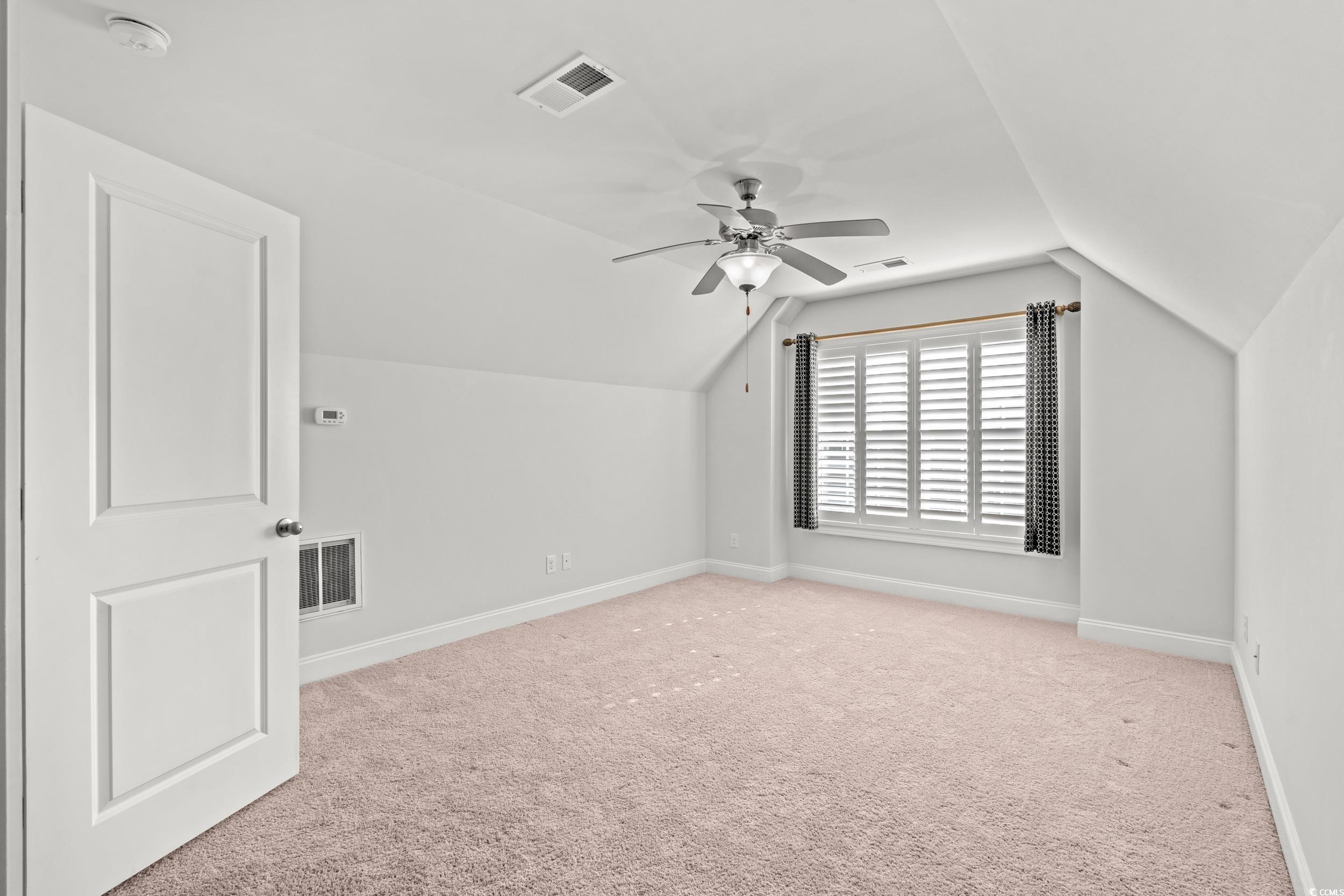 135 Parmelee Drive, Unit C Murrells Inlet, SC 29576 - Photo 23 of 37 Bonus room featuring vaulted ceiling, light carpet, and ceiling fan