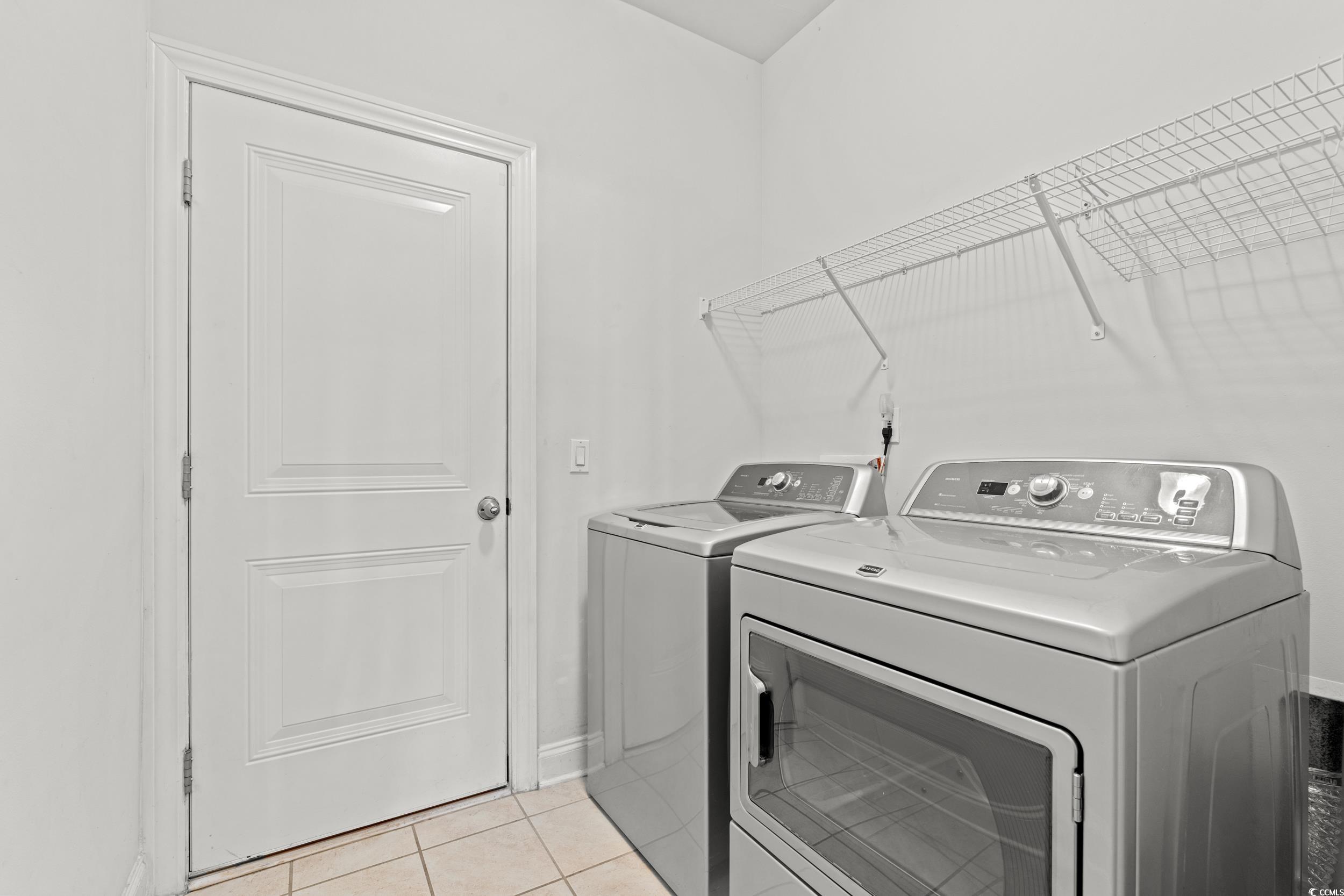 135 Parmelee Drive, Unit C Murrells Inlet, SC 29576 - Photo 26 of 37 Laundry room with light tile patterned floors and independent washer and dryer