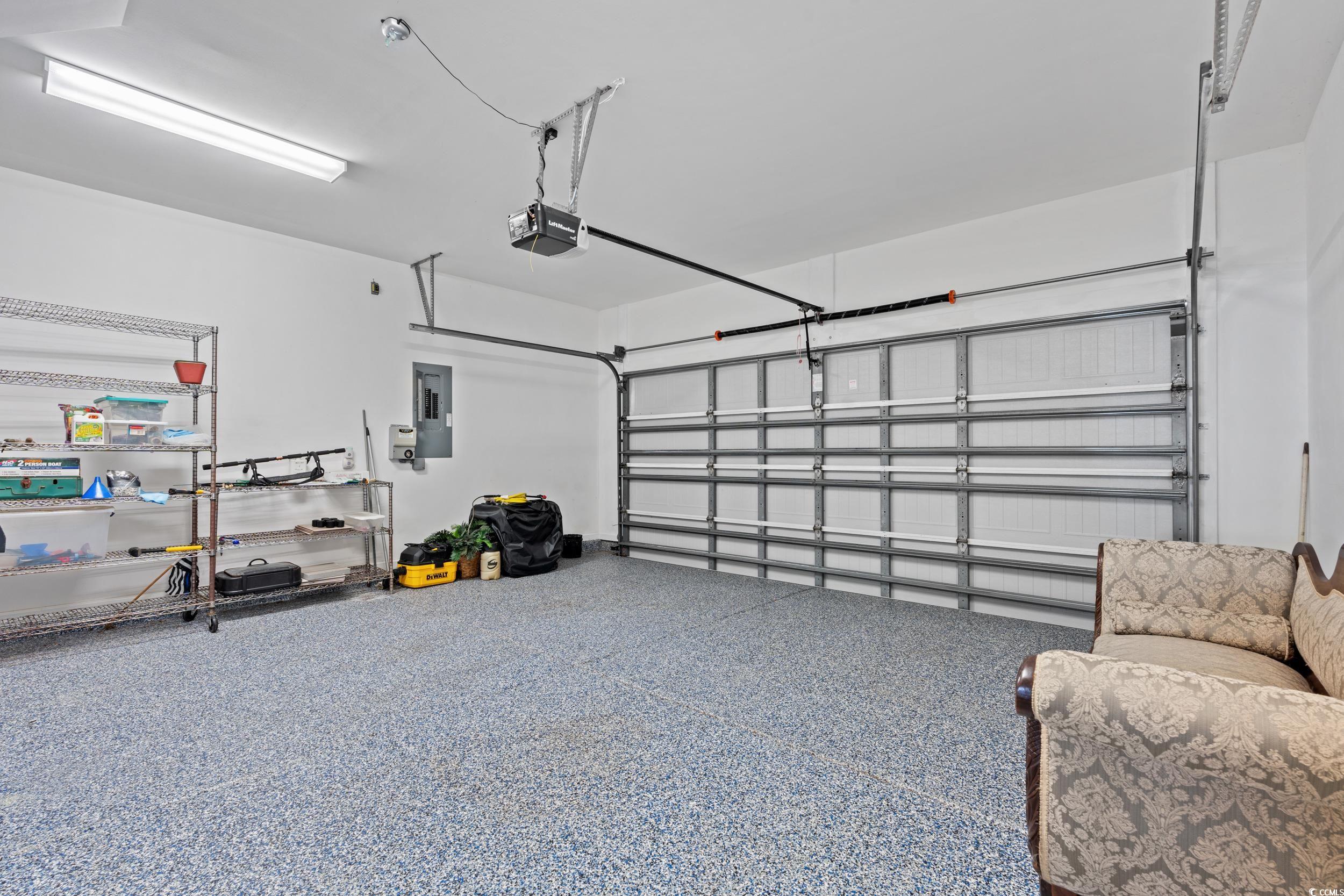 135 Parmelee Drive, Unit C Murrells Inlet, SC 29576 - Photo 27 of 37 Garage featuring electric panel and a garage door opener