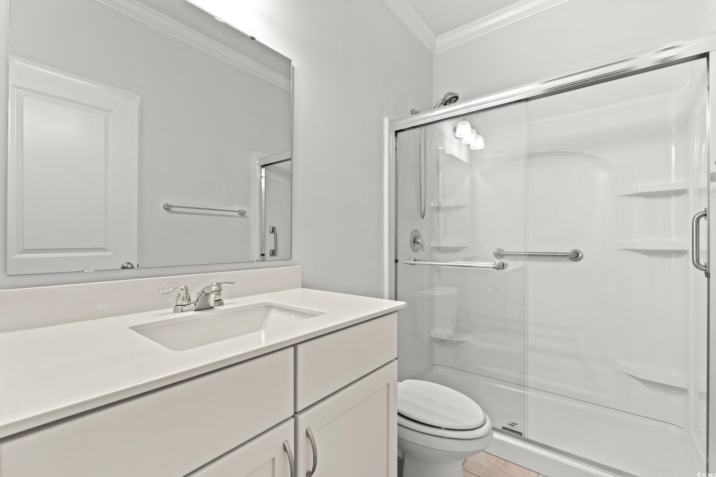 135 Parmelee Drive, Unit C Murrells Inlet, SC 29576 - Photo 6 of 37 Full bath featuring a shower stall, ornamental molding, and vanity