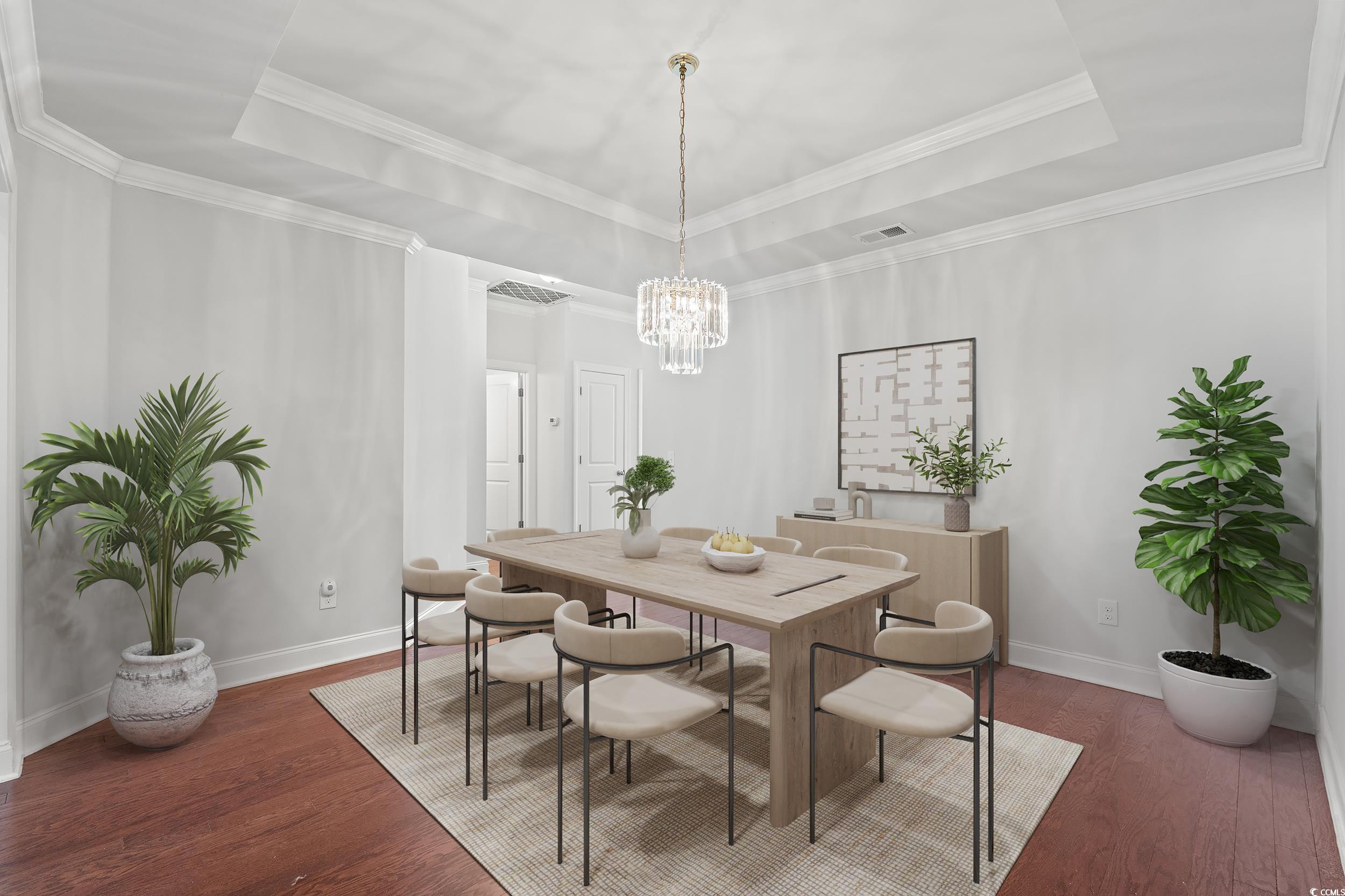 135 Parmelee Drive, Unit C Murrells Inlet, SC 29576 - Photo 7 of 37 Dining space featuring a raised ceiling, dark wood-style flooring, and crown molding