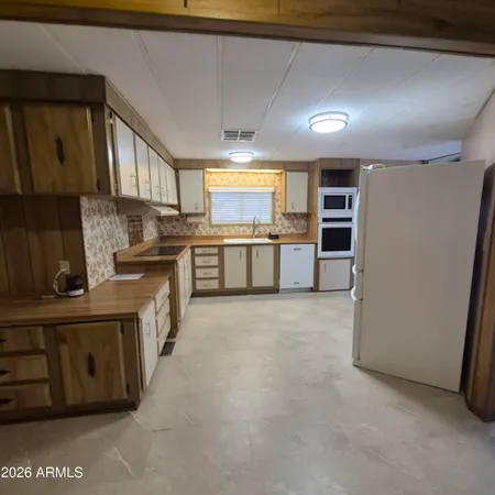 a large kitchen with a large counter top appliances and cabinets