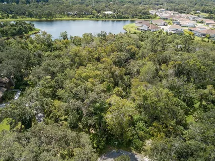 an aerial view of a houses with a lake view