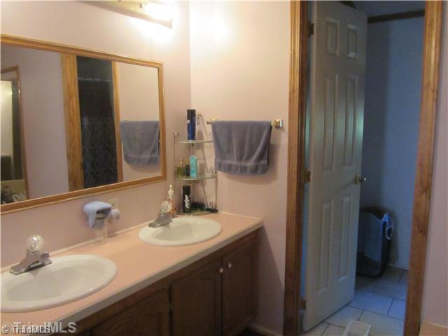 1853 Amostown Road Sandy Ridge, NC 27046 - Photo 15 of 16 Master Bath/Spa. Double Vanity, garden tub, new tile floor