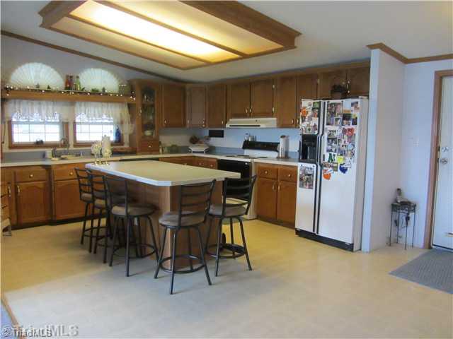 1853 Amostown Road Sandy Ridge, NC 27046 - Photo 8 of 16 Kitchen. Kitchen w/ island bar, lots of cabinets