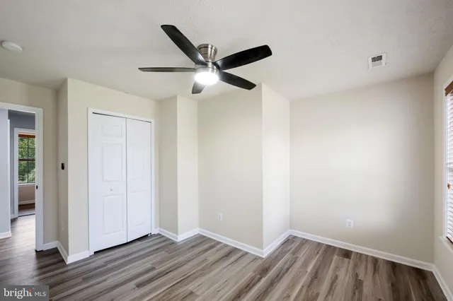 a kitchen with kitchen island a sink stove and wooden floor
