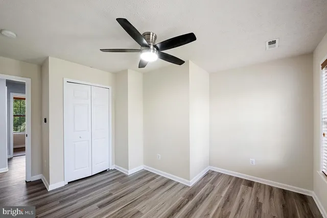 a kitchen with cabinets stainless steel appliances and window