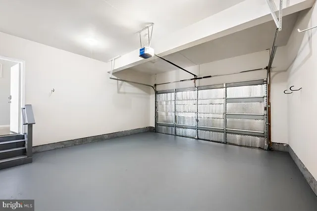 a kitchen with stainless steel appliances a microwave a stove and white cabinets