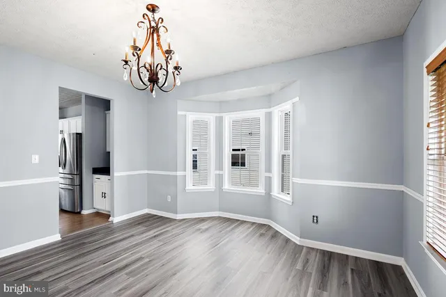 a living room with a fireplace and wooden floor