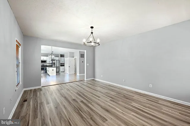 a view of a chair and tables in the backyard of the house