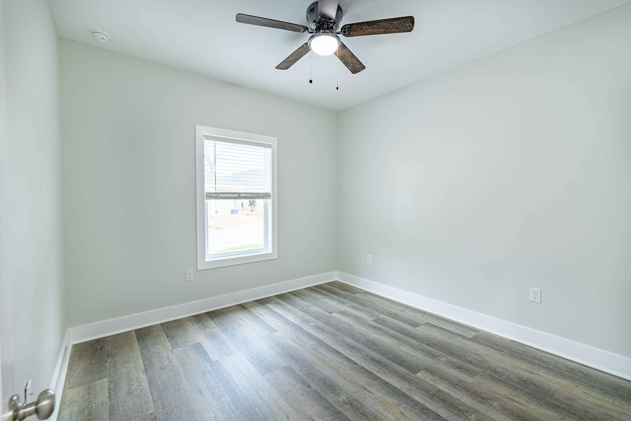 104 Clearing Way Valparaiso, FL 32580 - Photo 13 of 22 a view of empty room with wooden floor and fan