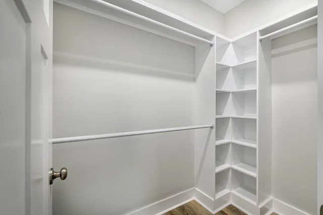 a bathroom with a granite countertop sink a toilet and mirror