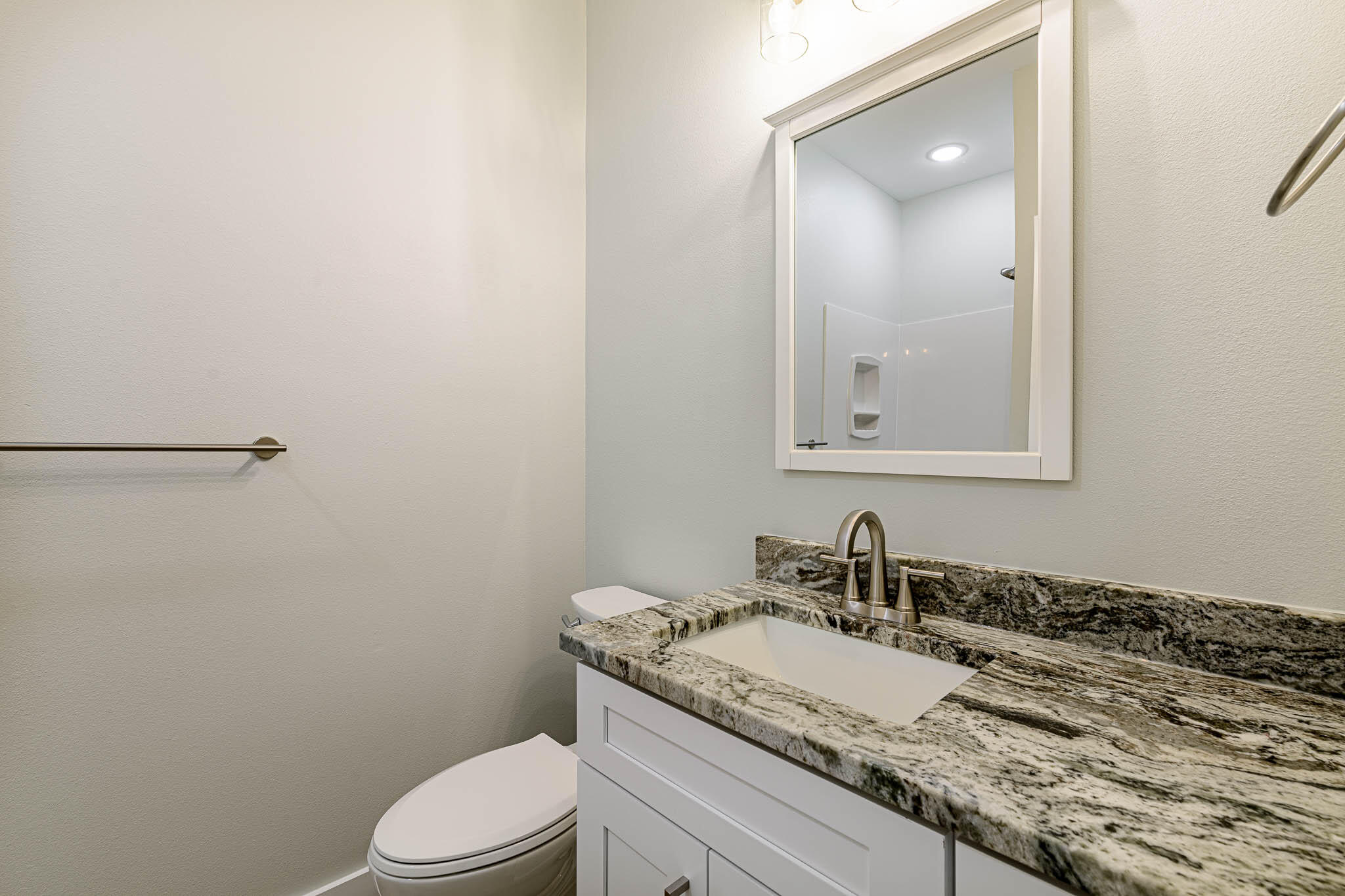 104 Clearing Way Valparaiso, FL 32580 - Photo 19 of 22 a bathroom with a granite countertop sink a toilet and mirror