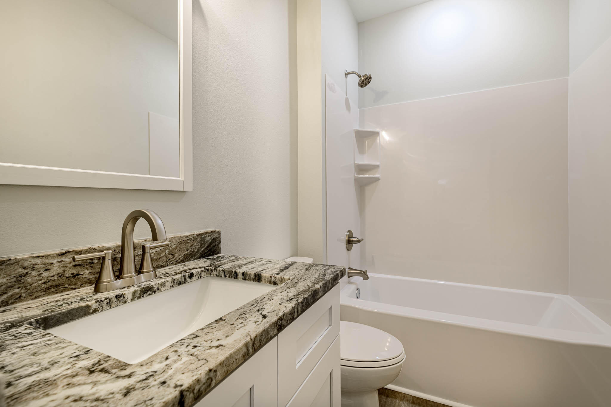 104 Clearing Way Valparaiso, FL 32580 - Photo 9 of 22 a bathroom with a granite countertop sink toilet and shower