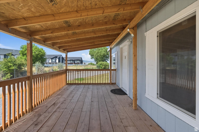 433 North 750 West Logan, UT 84321 - Photo 25 of 40 Covered outdoor deck with natural wood flooring and railing