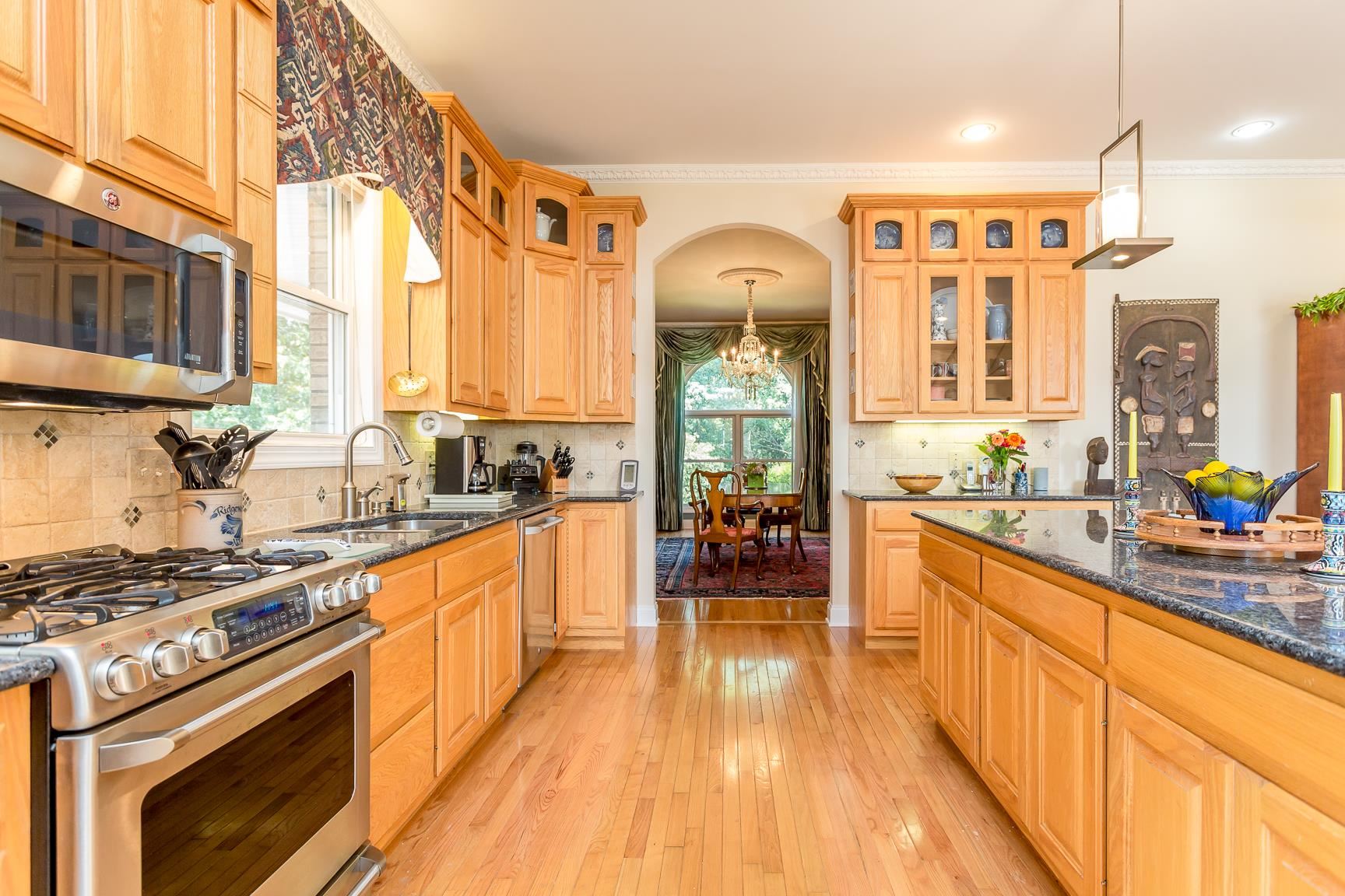 6403 Spring Hill Road Bridgewater, VA 22812 - Photo 16 of 52 a kitchen with stainless steel appliances a stove a sink dishwasher a refrigerator and wooden cabinets with wooden floor