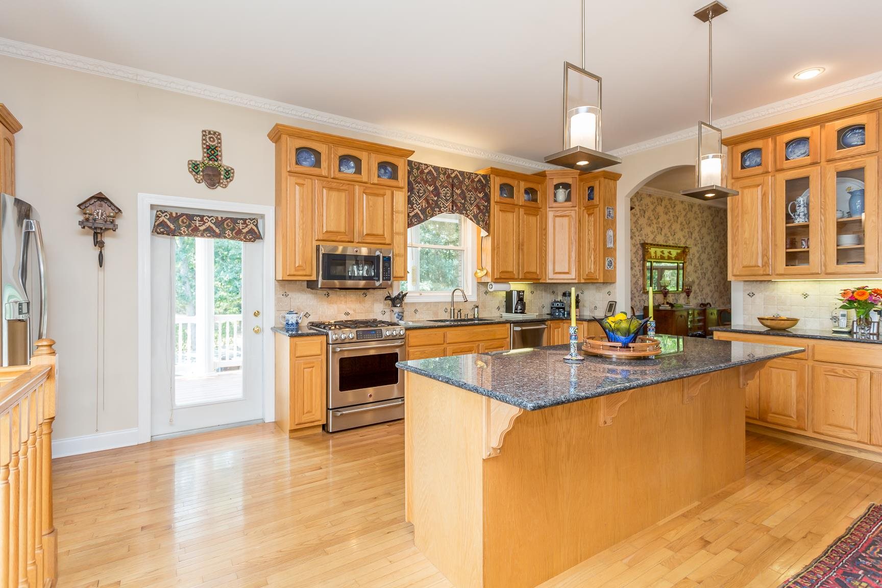 6403 Spring Hill Road Bridgewater, VA 22812 - Photo 18 of 52 a large kitchen with granite countertop a large counter top a sink stainless steel appliances and cabinets